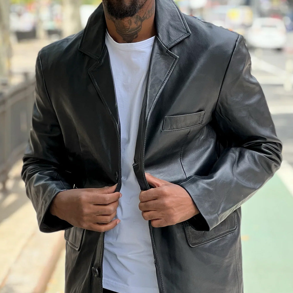 A man wearing a black leather blazer jacket.