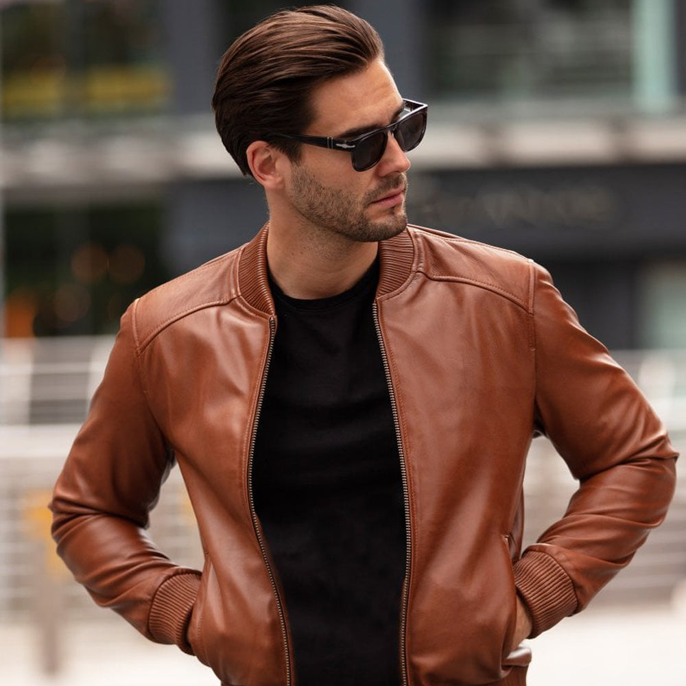 A man wearing stylish brown leather bomber jacket.
