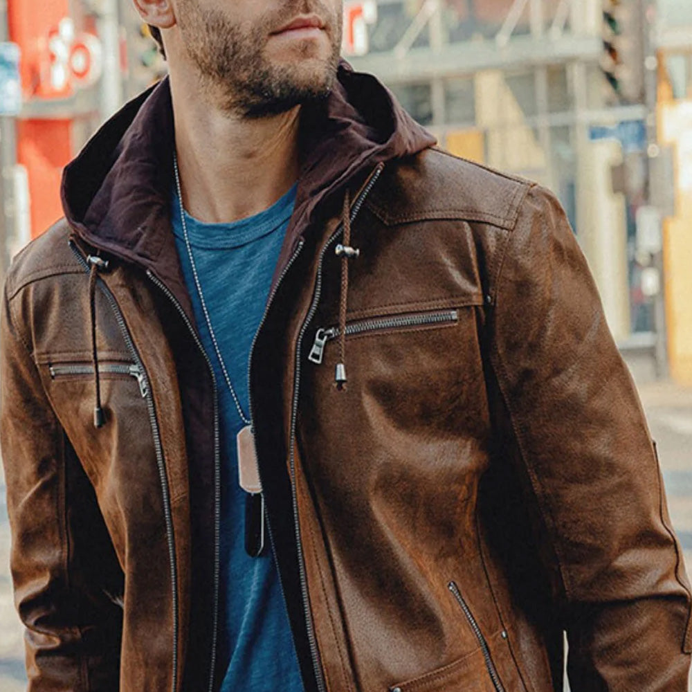 Close-up of a man wearing a brown leather hooded jacket.