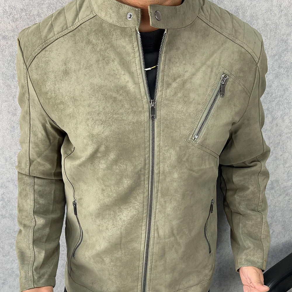 Close-up of a man wearing a olive green suede  jacket with a stand collar, zippered chest and waist pockets.