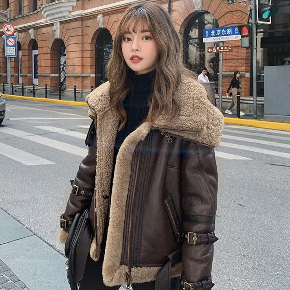 Woman wearing a stylish shearling leather jacket in winter
